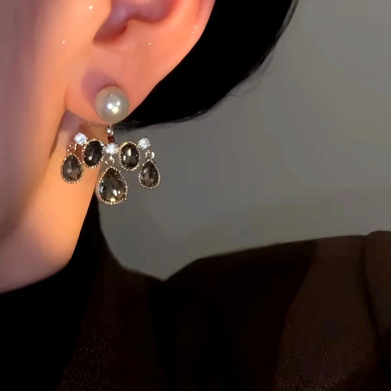 Model showcasing the dangle and style of the 14K Gold-Plated Luxury Front And Back Pearl Crystal Tassel Earrings