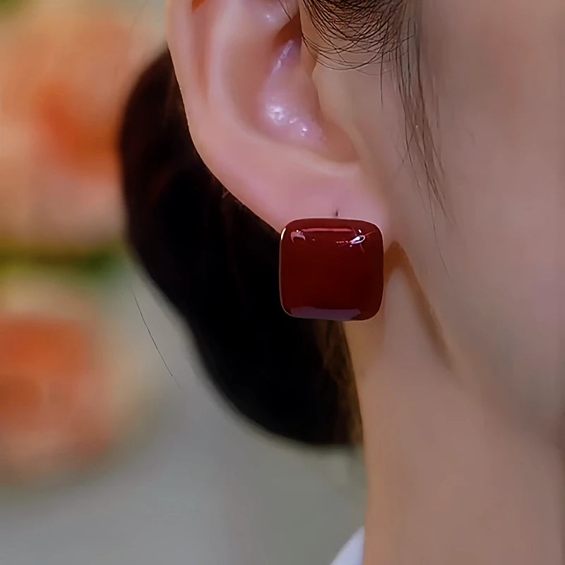 Model showcasing the dangle and style of the 14K Gold-Plated Luxury Glaze Stud Earrings