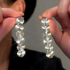 Close-up detail of the sparkling zircons and plating on the Fan Tassel Earrings