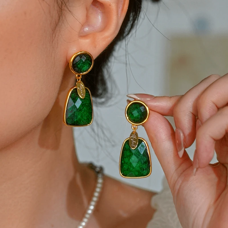 Model showcasing the dangle and style of the 14K Gold-Plated Luxury Green Crystal Tassel Earrings