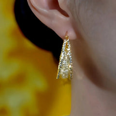 Model showcasing the dangle and style of the 14K Gold-Plated Luxury Hollow Hoop Earrings