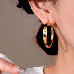 Close-up detail of the sparkling zircons and plating on the Letter Hoop Earrings