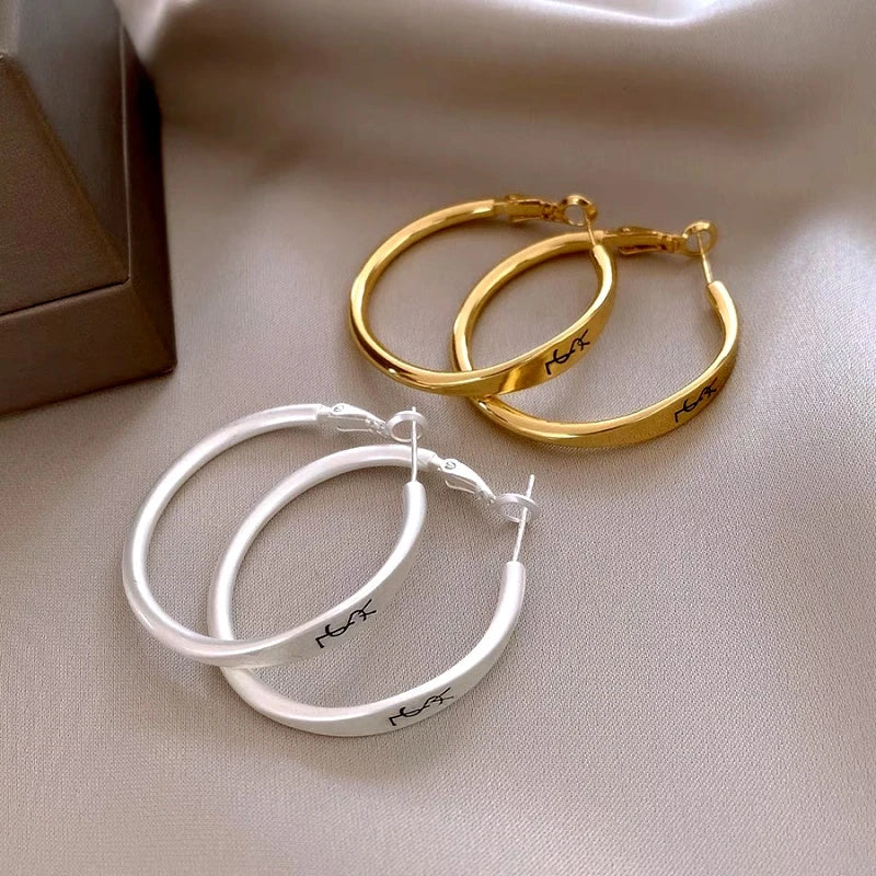 Angled view of the 14K Gold-Plated Luxury Letter Big Hoop Earrings