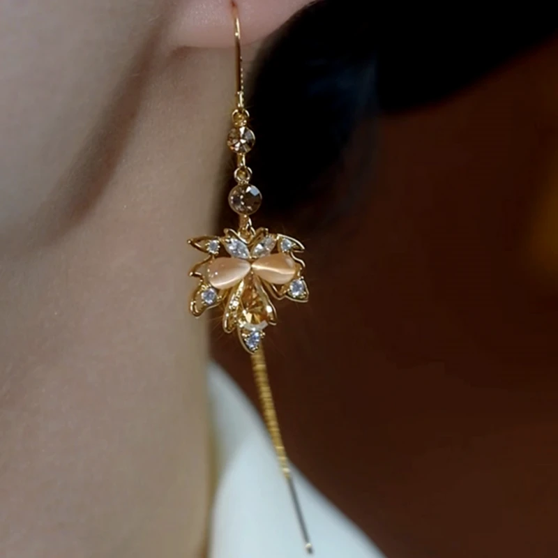 Model showcasing the dangle and style of the 14K Gold-Plated Luxury Maple Leaf Threader Earrings