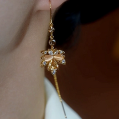 Model showcasing the dangle and style of the 14K Gold-Plated Luxury Maple Leaf Threader Earrings