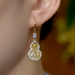 Model showcasing the dangle and style of the 14K Gold-Plated Luxury Mesh Gourd Earrings