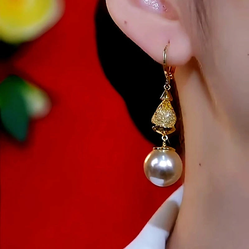 Model showcasing the dangle and style of the 14K Gold-Plated Luxury Mesh Pearl Earrings