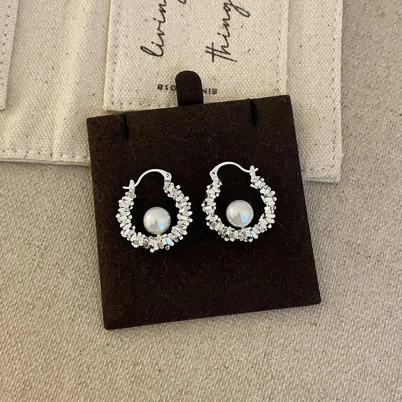 Close-up detail of the sparkling zircons and plating on the Pearl Hoop Earrings