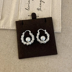 Close-up detail of the sparkling zircons and plating on the Pearl Hoop Earrings