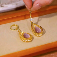 Angled view of the 14K Gold-Plated Luxury Pink Cat's Eye Stone Water Drop Earrings