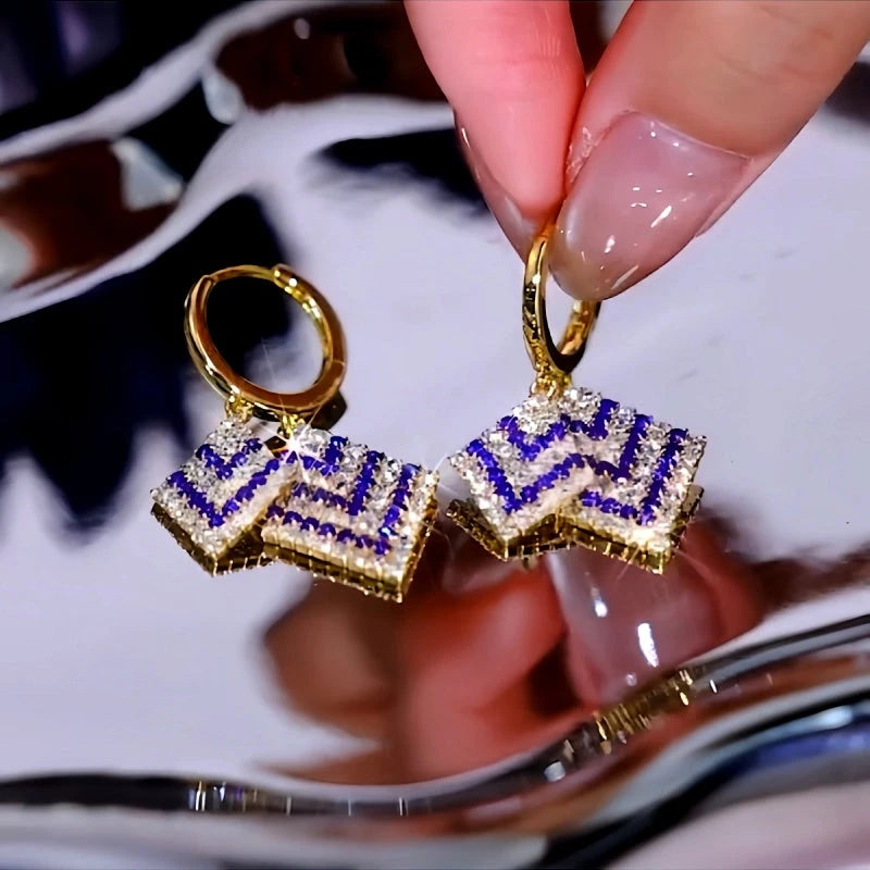 Angled view of the 14K Gold-Plated Luxury Purple And White Diamond Tassel Earrings