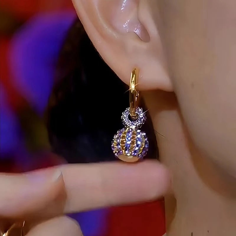 Model showcasing the dangle and style of the 14K Gold-Plated Luxury Purple Crystal Ball Earrings