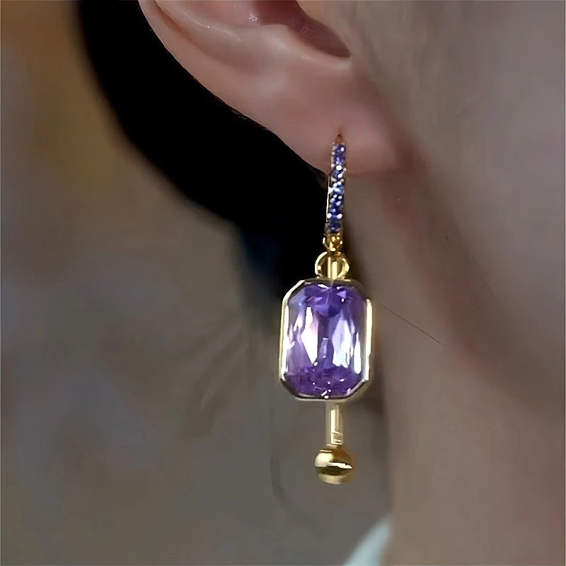 Model showcasing the dangle and style of the 14K Gold-Plated Luxury Purple Diamond Tassel Earrings