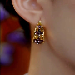 Close-up detail of the sparkling zircons and plating on the Purple Geometric Earrings