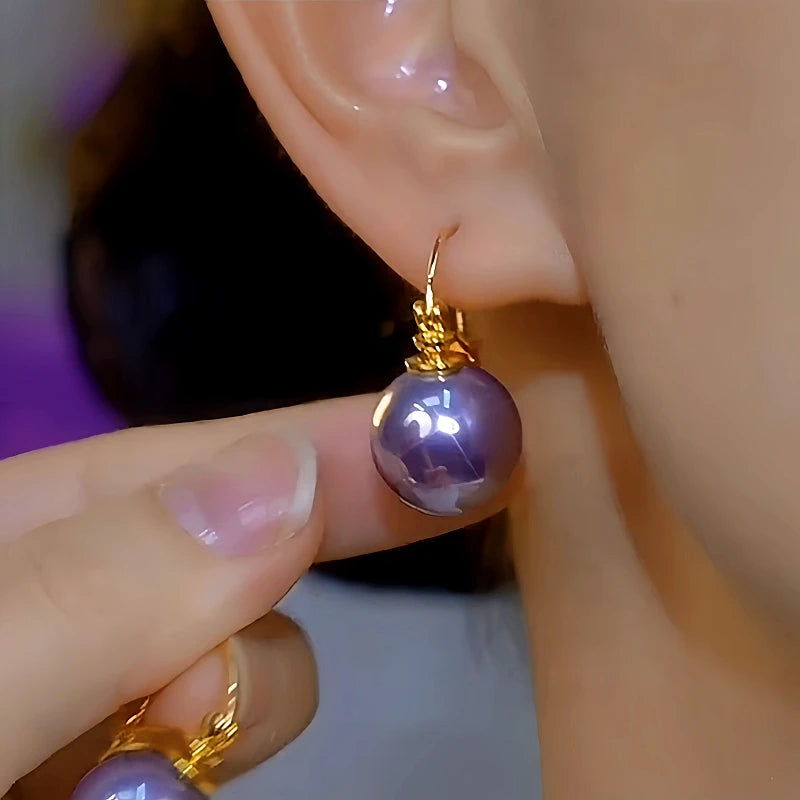 Angled view of the 14K Gold-Plated Luxury Purple Pearl Earrings