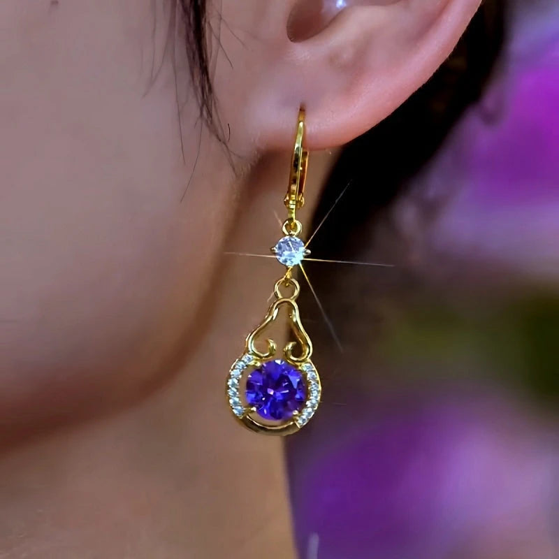 Model showcasing the dangle and style of the 14K Gold-Plated Luxury Purple Zircon Diamond Water Drop Earrings