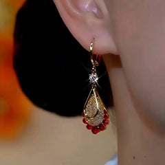 Model showcasing the dangle and style of the 14K Gold-Plated Luxury Red Diamond Mesh Water Drop Earrings