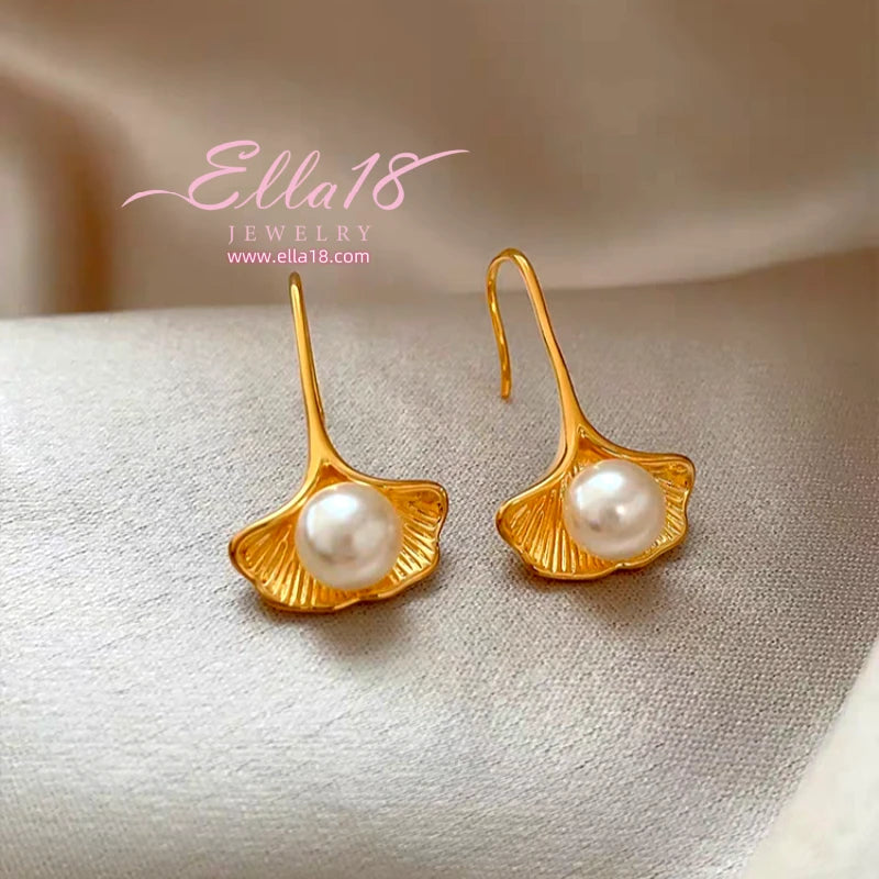 Model showcasing the dangle and style of the 14K Gold-Plated Luxury Shell Pearl Ear Hook Earrings