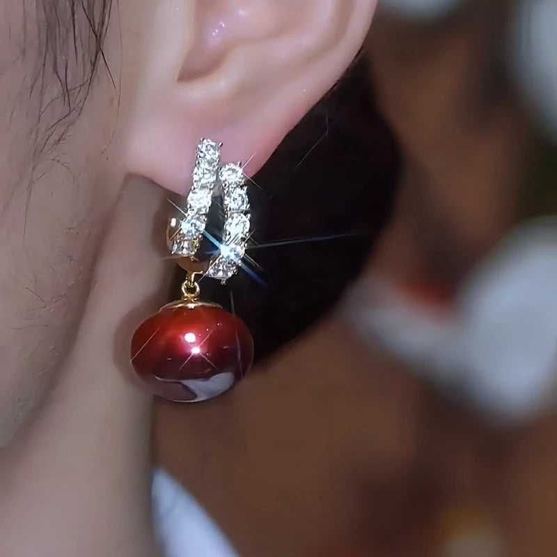 Close-up detail of the sparkling zircons and plating on the Red Pearl Earrings