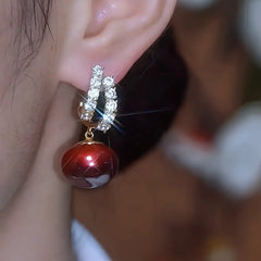 Close-up detail of the sparkling zircons and plating on the Red Pearl Earrings