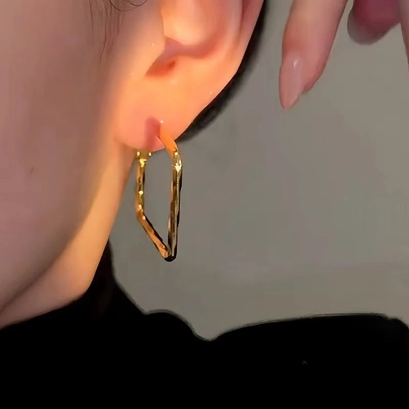 Model showcasing the dangle and style of the 14K Gold-Plated Luxury Square Earrings