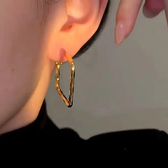 Model showcasing the dangle and style of the 14K Gold-Plated Luxury Square Earrings