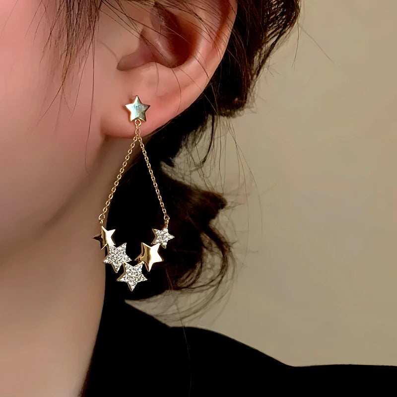 Model showcasing the dangle and style of the 14K Gold-Plated Luxury Star Tassel Earrings