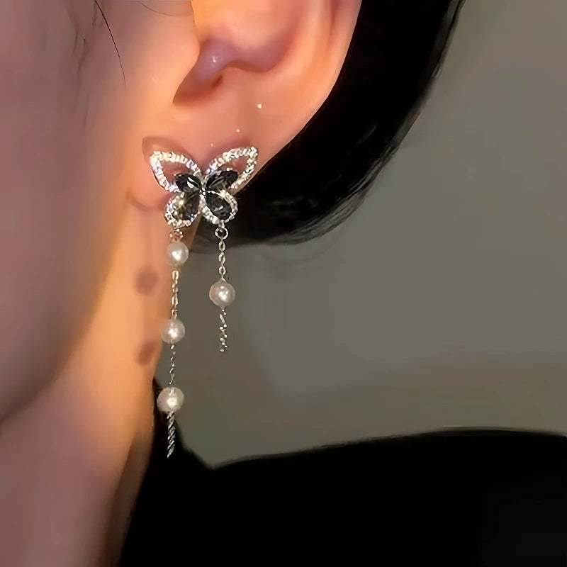 Model showcasing the dangle and style of the 14K Gold-Plated Luxury Zircon Black Diamond Butterfly Pearl Tassel Earrings