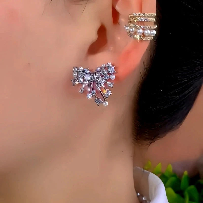Model showcasing the dangle and style of the 14K Gold-Plated Luxury Zircon Bow Earrings