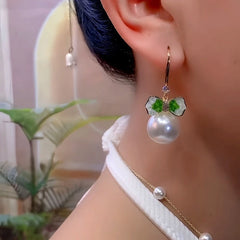 Model showcasing the dangle and style of the 14K Gold-Plated Luxury Zircon Bow Pearl Ear Hook Earrings