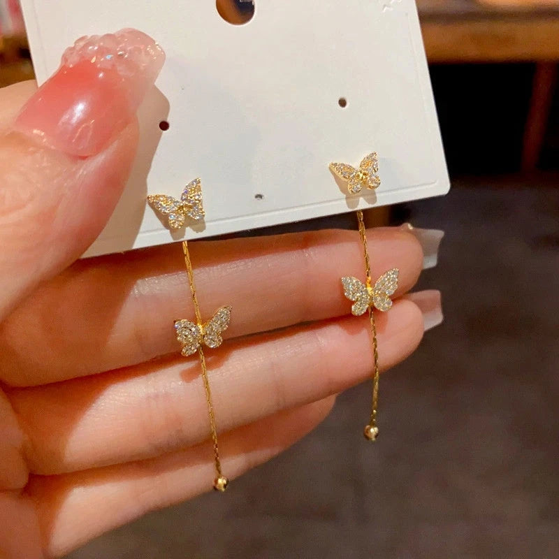 Model showcasing the dangle and style of the 14K Gold-Plated Luxury Zircon Butterfly Tassel Earrings