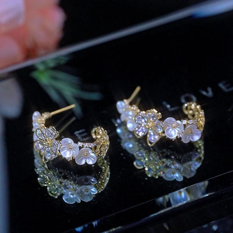 Angled view of the 14K Gold-Plated Luxury Zircon C-Shaped Flower Earrings