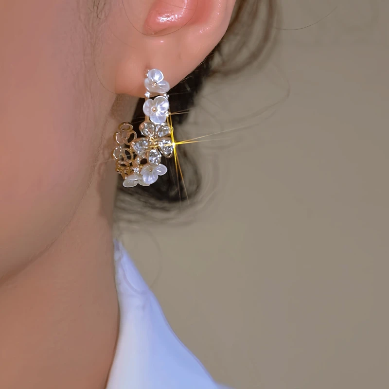 Model showcasing the dangle and style of the 14K Gold-Plated Luxury Zircon C-Shaped Flower Earrings
