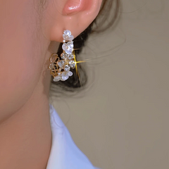 Model showcasing the dangle and style of the 14K Gold-Plated Luxury Zircon C-Shaped Flower Earrings