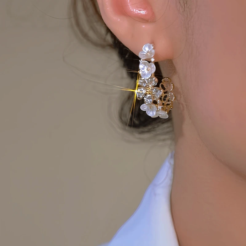 Close-up detail of the sparkling zircons and plating on the C-Shaped Flower Earrings