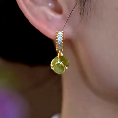 Model showcasing the dangle and style of the 14K Gold-Plated Luxury Zircon Cat's Eye Stone Earrings