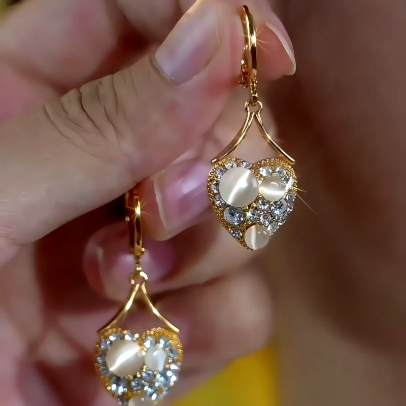Close-up detail of the sparkling zircons and plating on the Cat's Eye Heart Earrings