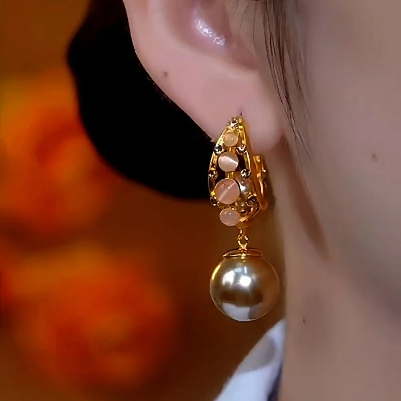 Close-up detail of the sparkling zircons and plating on the Cat's Eye Pearl Earrings