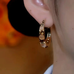 Model showcasing the dangle and style of the 14K Gold-Plated Luxury Zircon Cat's Eye Stone Pearl Hoop Earrings