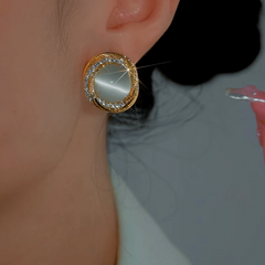 Angled view of the 14K Gold-Plated Luxury Zircon Cat's Eye Stone Stud Earrings