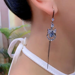 Model showcasing the dangle and style of the 14K Gold-Plated Luxury Zircon Diamond Bow Ear Hook Earrings