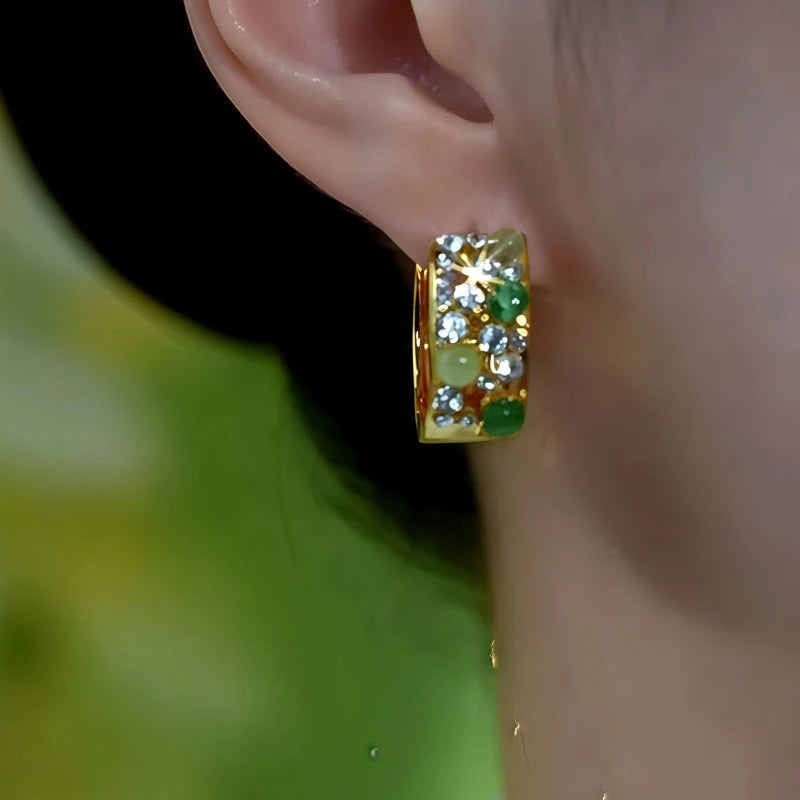 Model showcasing the dangle and style of the 14K Gold-Plated Luxury Zircon Diamond Cat's Eye Stone Wide Hoop Earrings