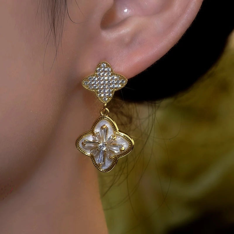Model showcasing the dangle and style of the 14K Gold-Plated Luxury Zircon Diamond Clover Earrings
