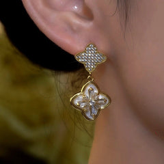 Close-up detail of the sparkling zircons and plating on the Clover Diamond Earrings