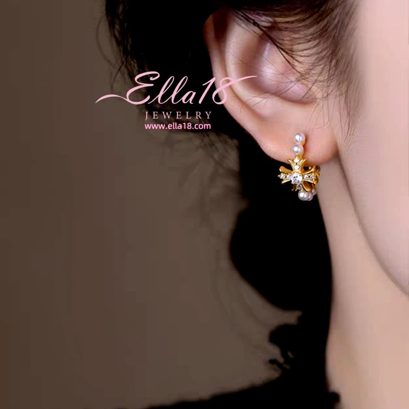 Close-up detail of the sparkling zircons and plating on the Cross Pearl Earrings