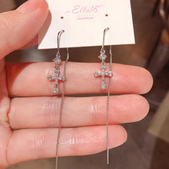 Model showcasing the dangle and style of the 14K Gold-Plated Luxury Zircon Diamond Cross Threader Earrings