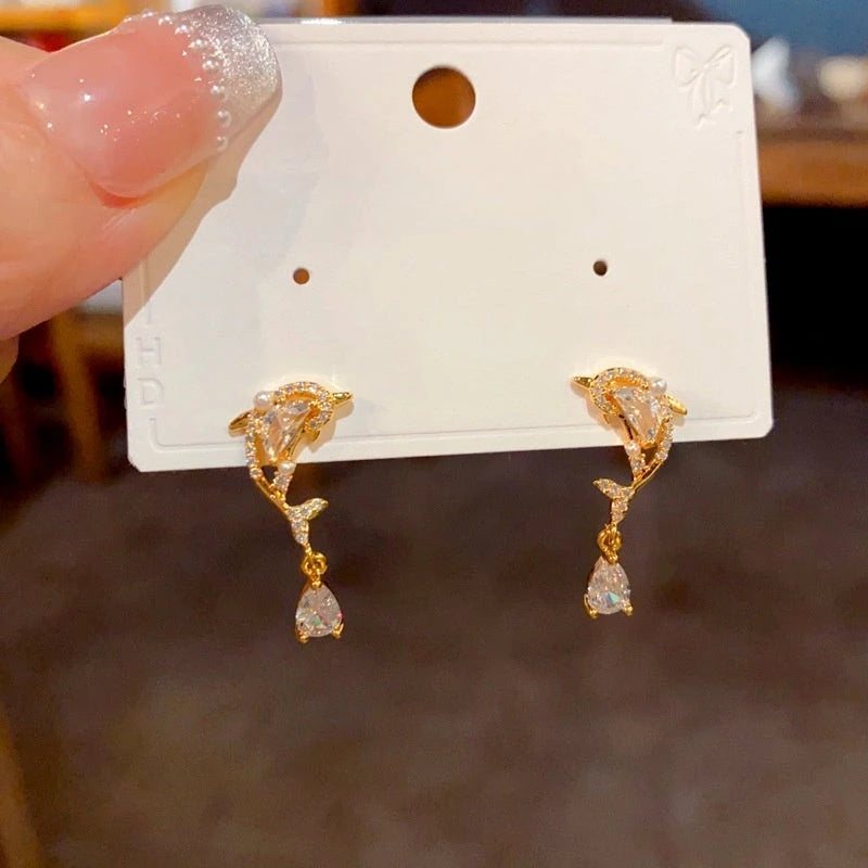 Model showcasing the dangle and style of the 14K Gold-Plated Luxury Zircon Diamond Dolphin Water Drop Earrings