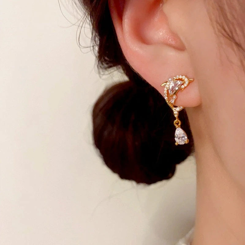 Close-up detail of the sparkling zircons and plating on the Dolphin Drop Earrings