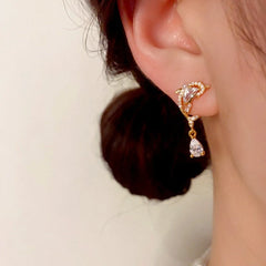 Close-up detail of the sparkling zircons and plating on the Dolphin Drop Earrings