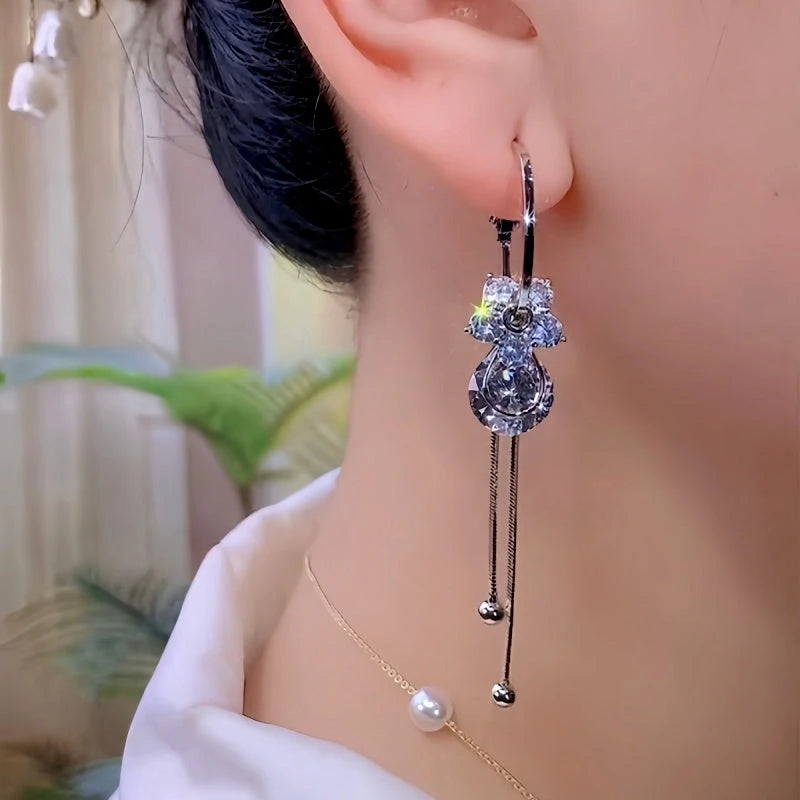 Model showcasing the dangle and style of the 14K Gold-Plated Luxury Zircon Diamond Flower Earrings